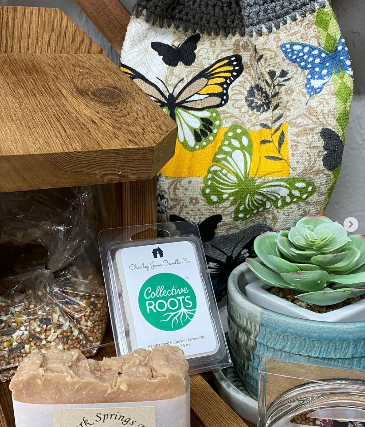 Awax melt bar is sitting on a wooden table next to a potted plant.
