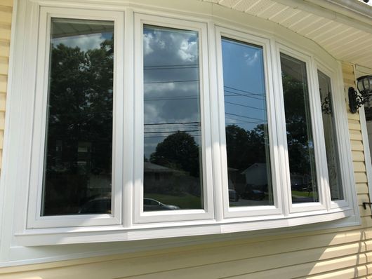 A white window on the side of a house