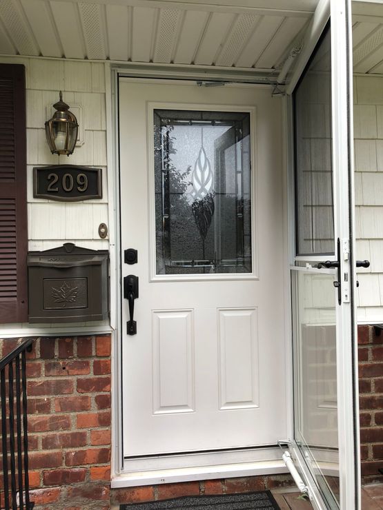 The front door of a house with the number 209 on it.