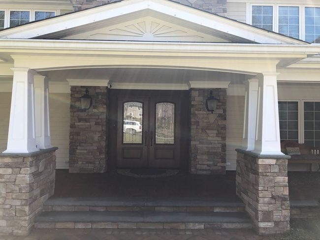 The front of a house with a porch and stairs