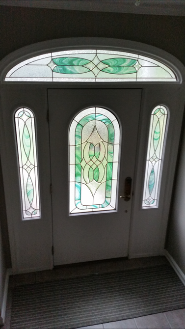 A white door with a stained glass window in the middle of it.