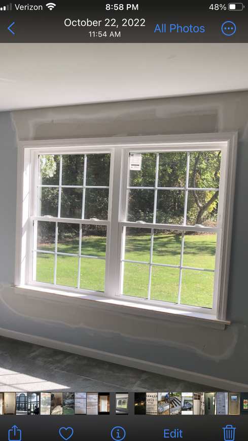 A picture of a window in a room on a cell phone.