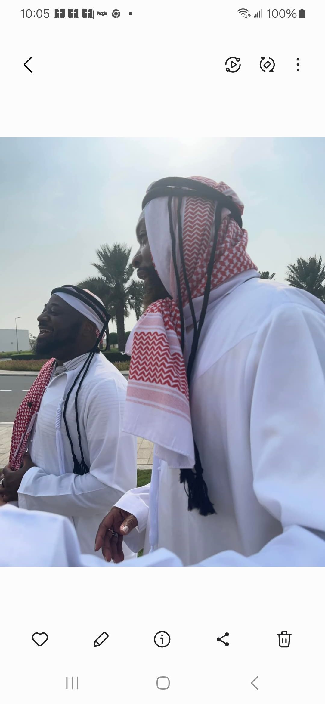 A group of men in traditional arabic clothing are standing next to each other.