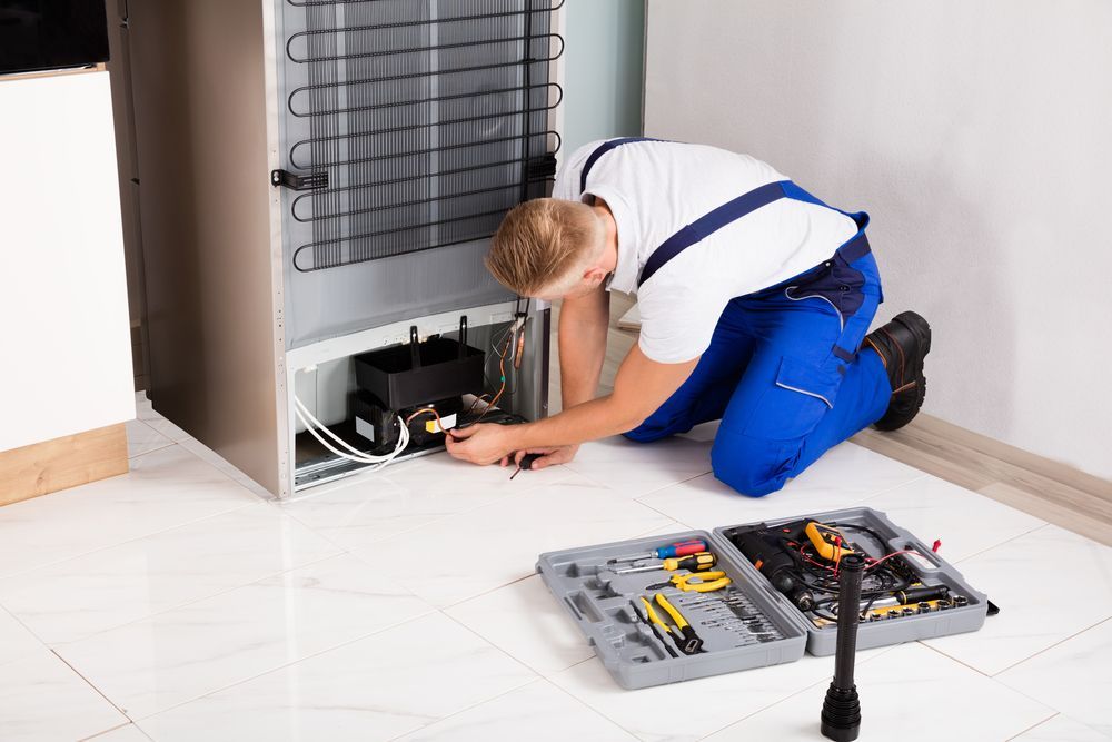 Technician Repairs Refrigerator Compressor — East Coast Air In Raymond Terrace, NSW