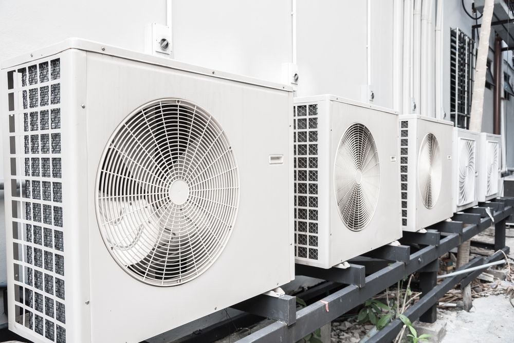A Row Of Air Conditioners Are Lined Up Outside Of A Building — East Coast Air In East Maitland, NSW