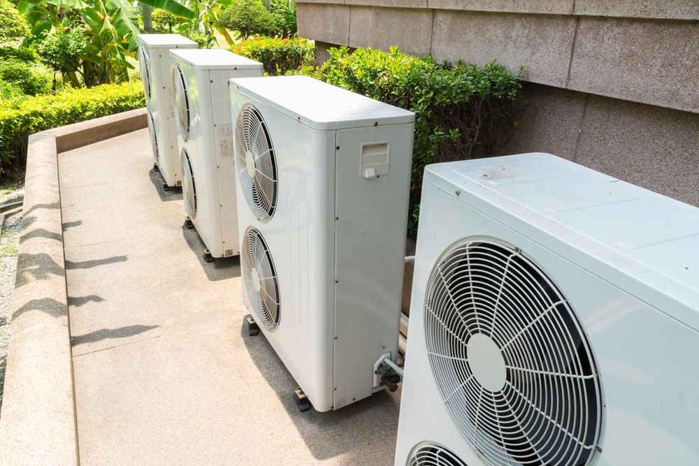 A Row Of Air Conditioners Are Sitting Outside Of A Building — East Coast Air In Cessnock, NSW