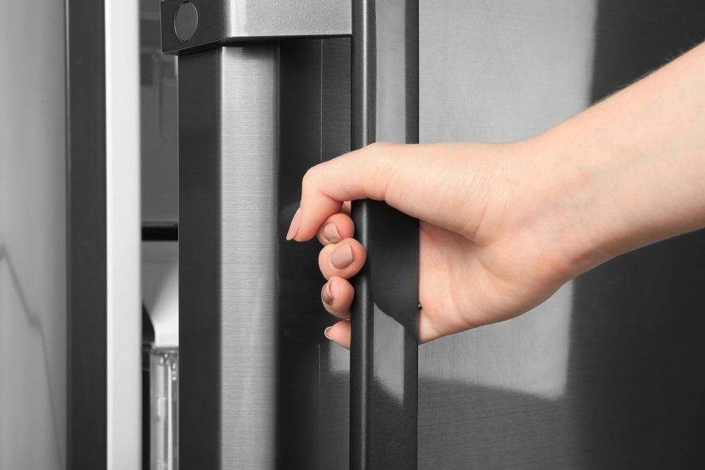 A Person Is Opening A Refrigerator Door With Their Hand — East Coast Air In East Maitland, NSW