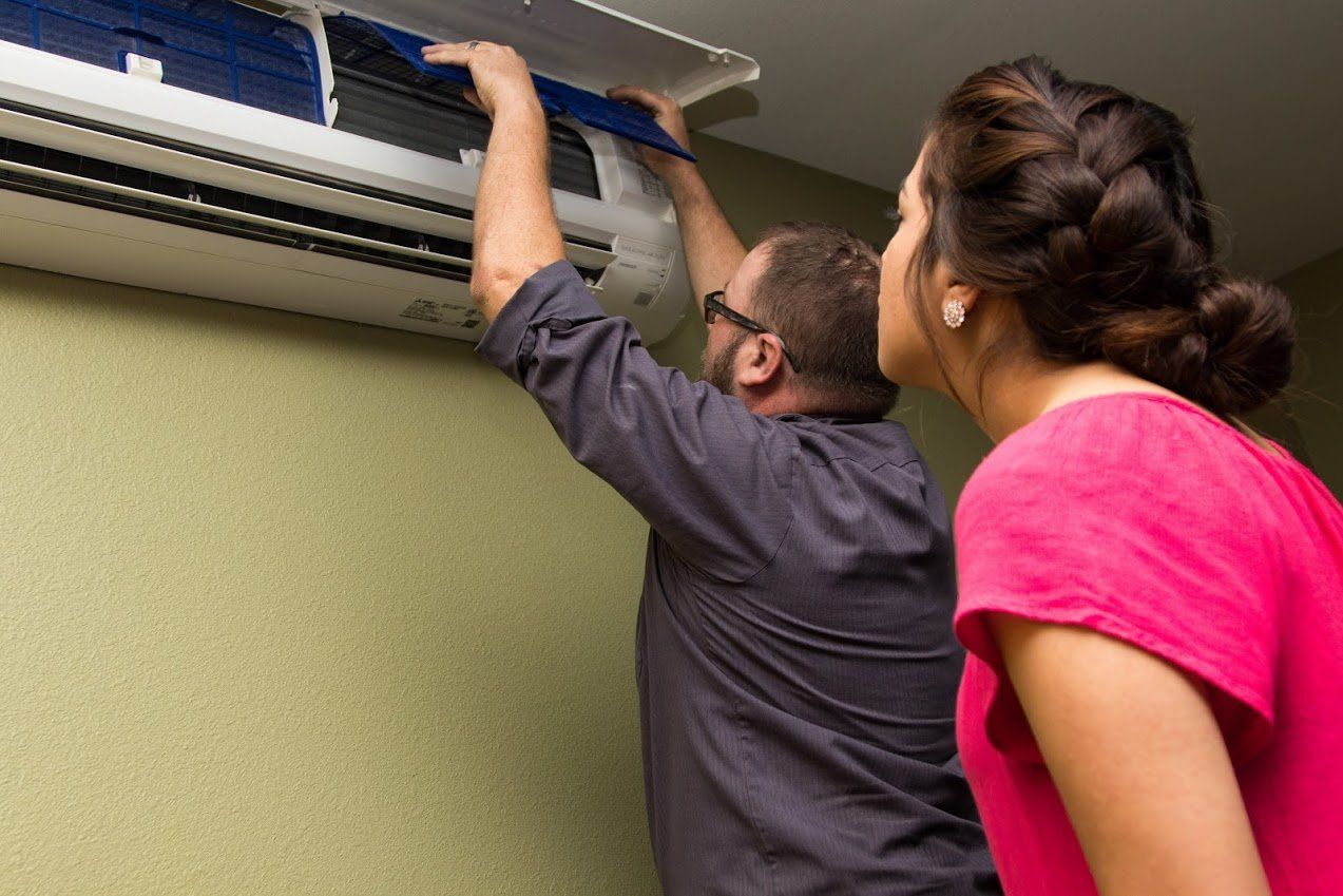 Air Conditioning Repair — Man Repairing Aircon in Irving, TX Air Conditioning Repair — Man Repairing Aircon in Irving, TX