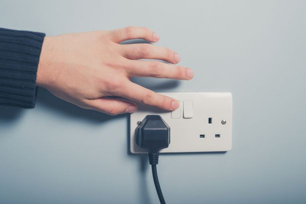 man turning off the switch before starting basement restoration