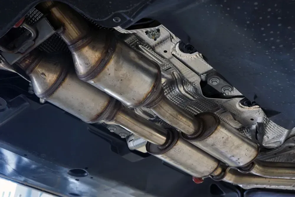 Catalytic Converters and Exhaust Pipes Under a Car, Metal Components — Carline Automotive and Exhausts in Belmont, NSW