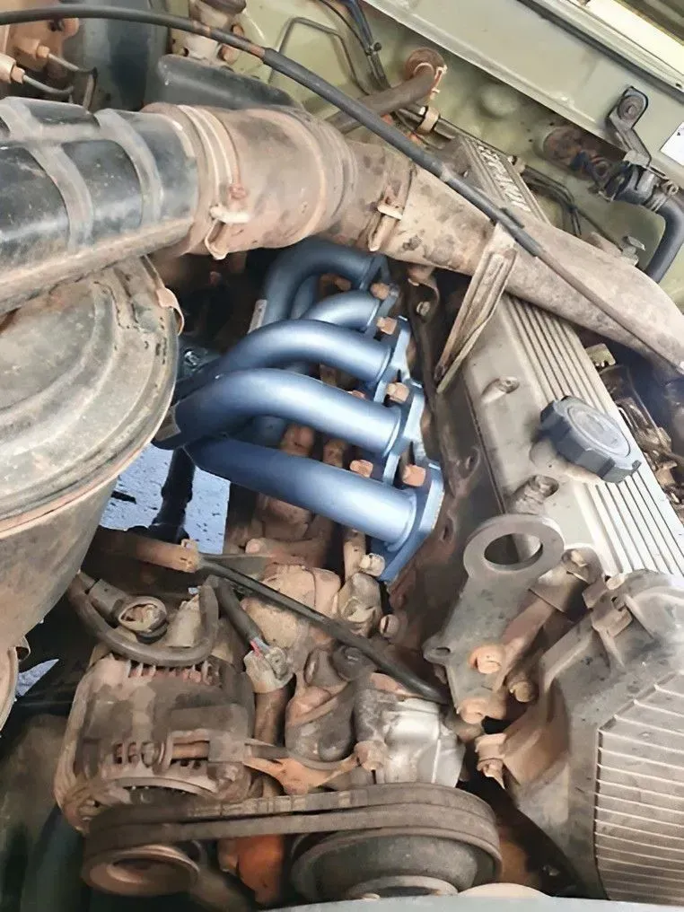 Blue Exhaust Headers Installed on an Engine, With Black Air Intake — Carline Automotive and Exhausts in Belmont, NSW