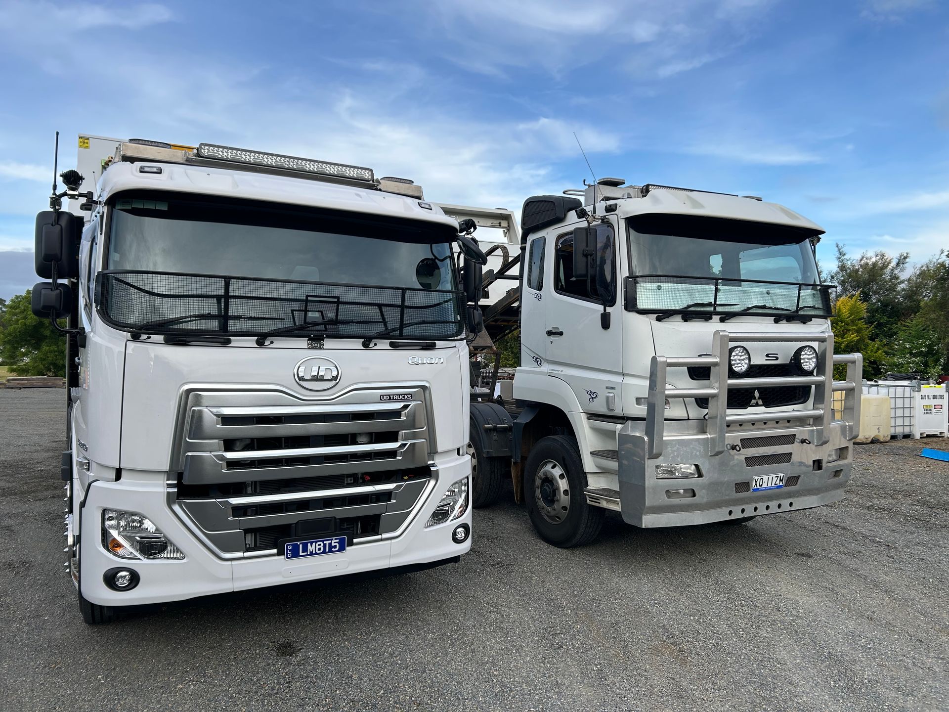 A Dump Truck Is Parked In Front Of A House On A Dirt Road — Little Mates Towing & Transport Pty Ltd In Glenlee, QLD