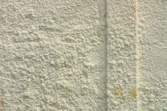 A close up of a white wall with a grainy texture.