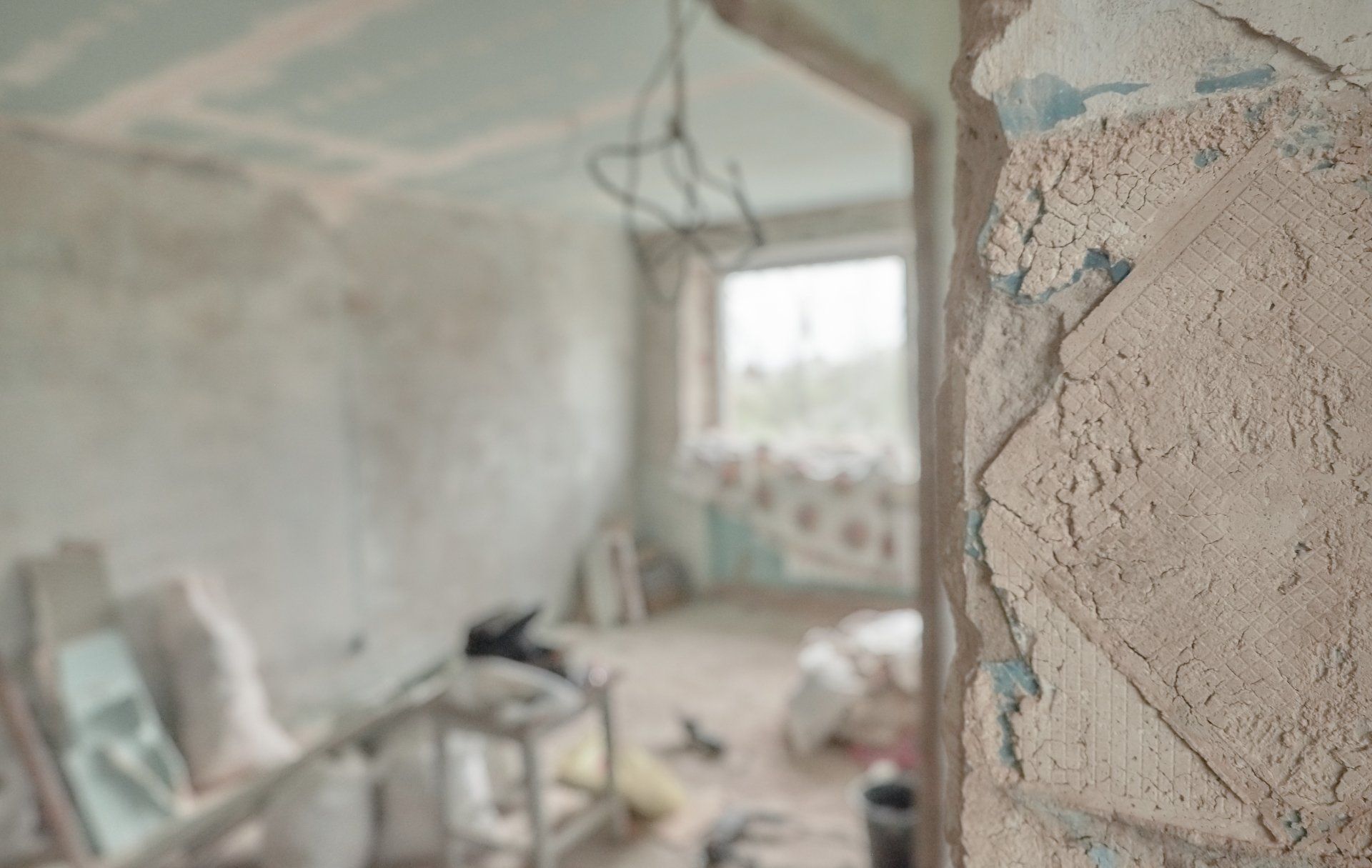 A blurred image of a room under construction with a window.