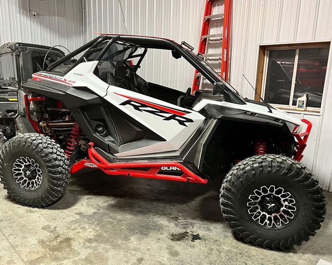 White and red Polaris RZR side-by-side ATV | Powell Auto & Offroad