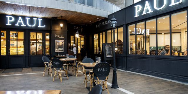 A restaurant called paul with tables and chairs outside
