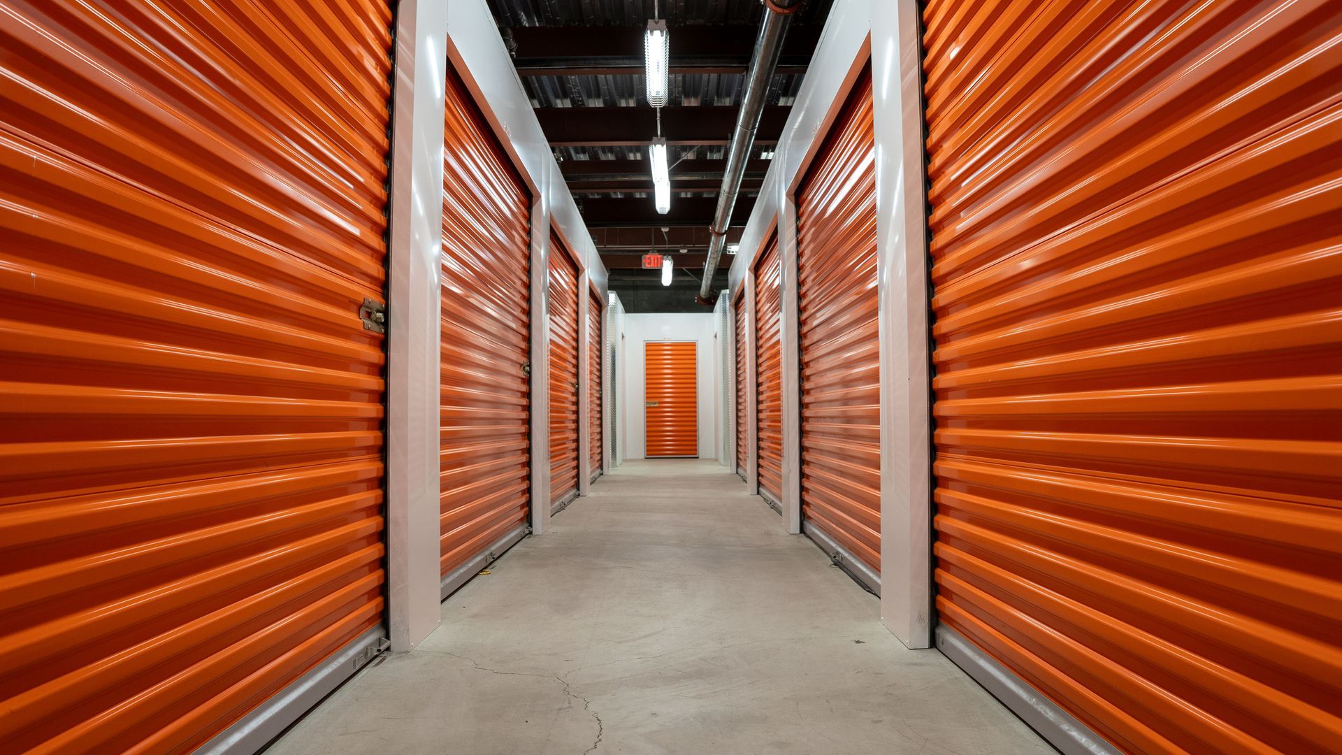 Empty hallway with orange garage doors