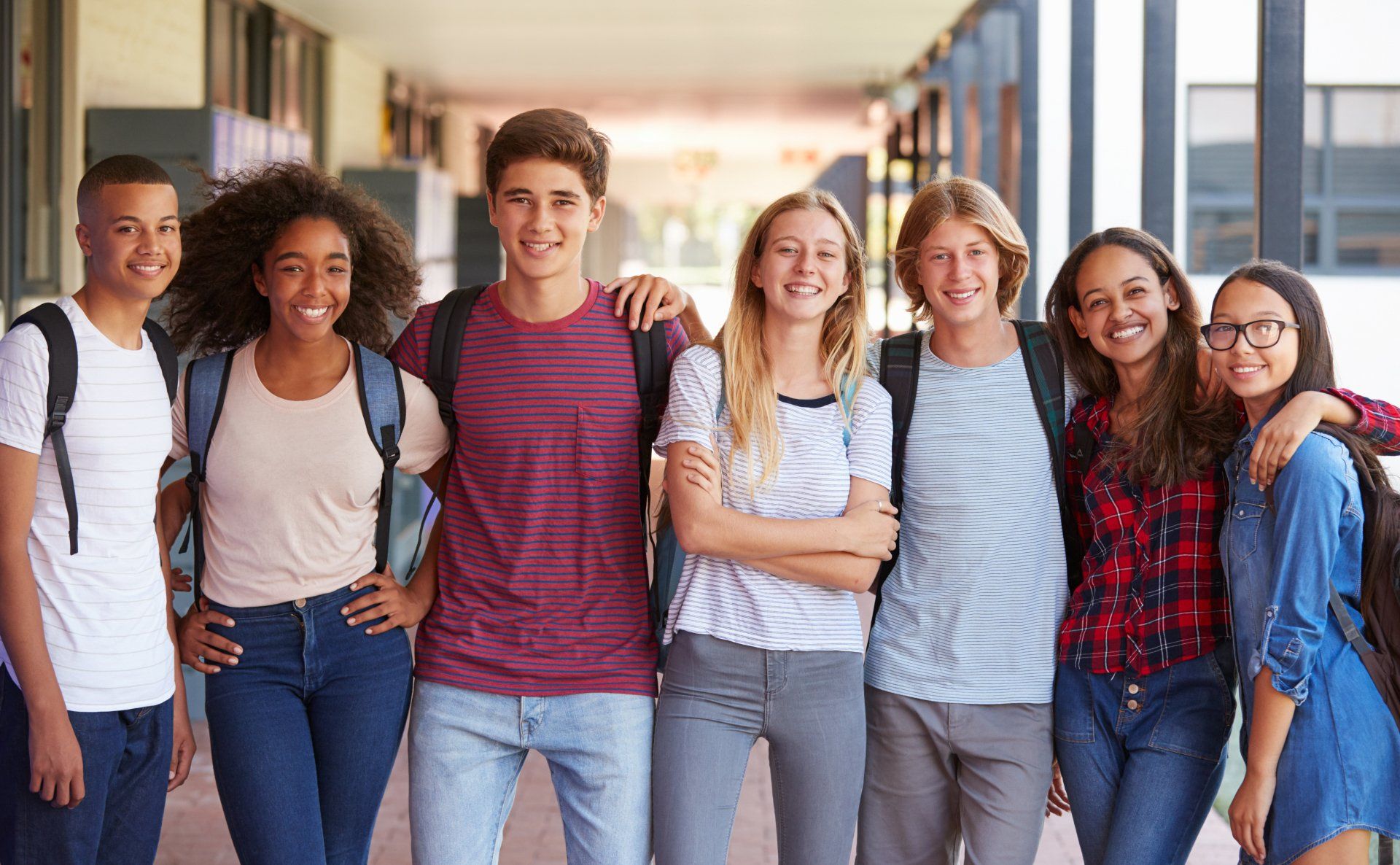 Students standing side by side smiling at the camera