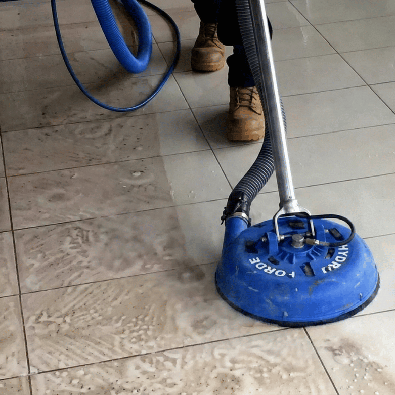 Technician using industrial-grade tile and grout cleaning machine in Calgary home