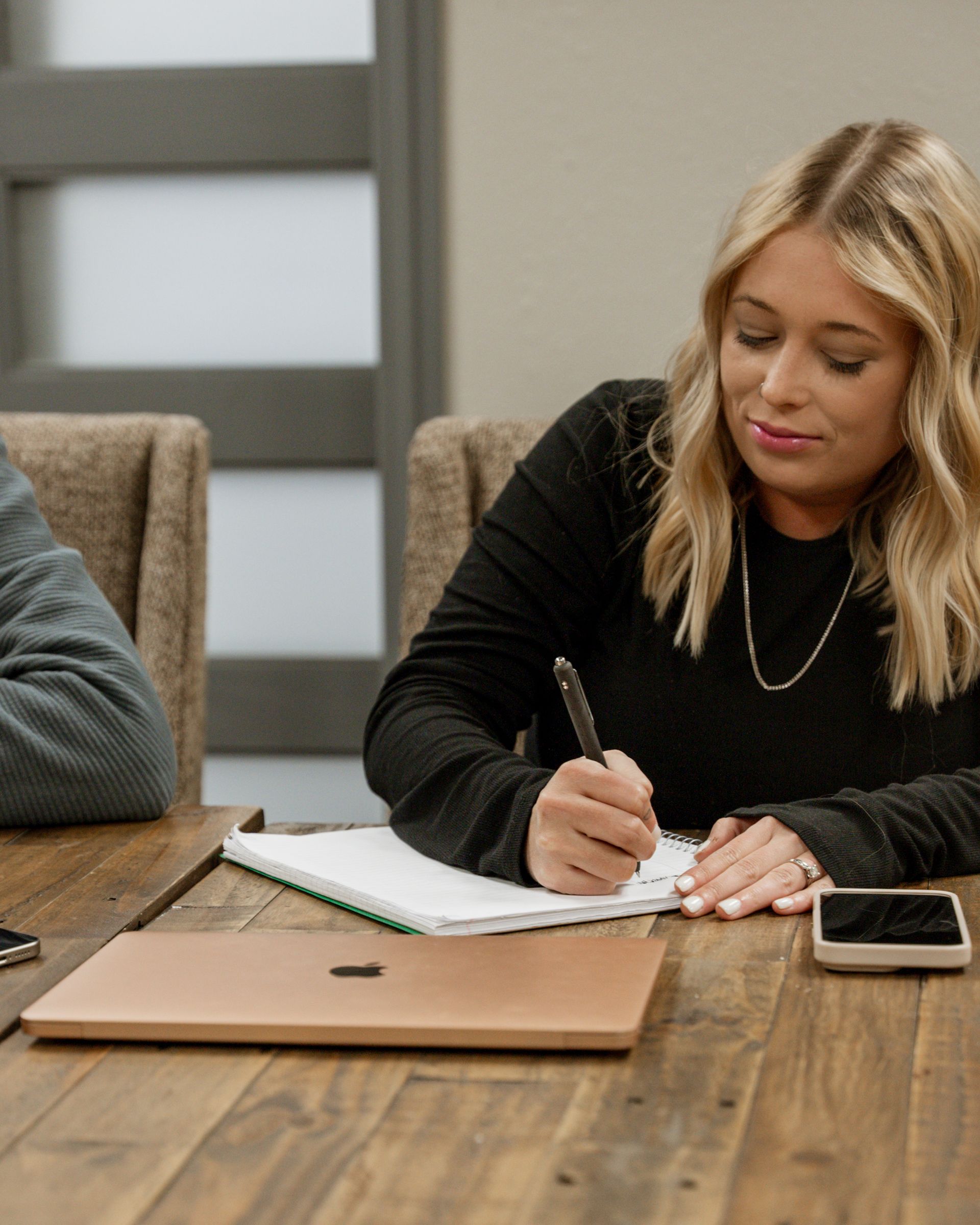 Woman taking notes in a meeting