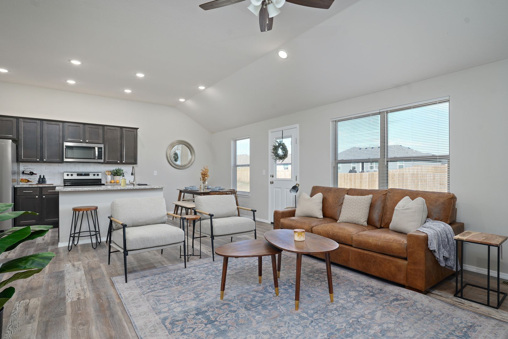 Open plan living room with a large brown couch