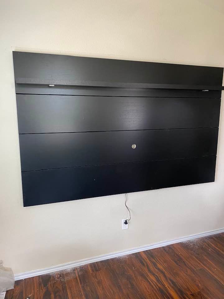 Floating media shelf installed under a mounted TV