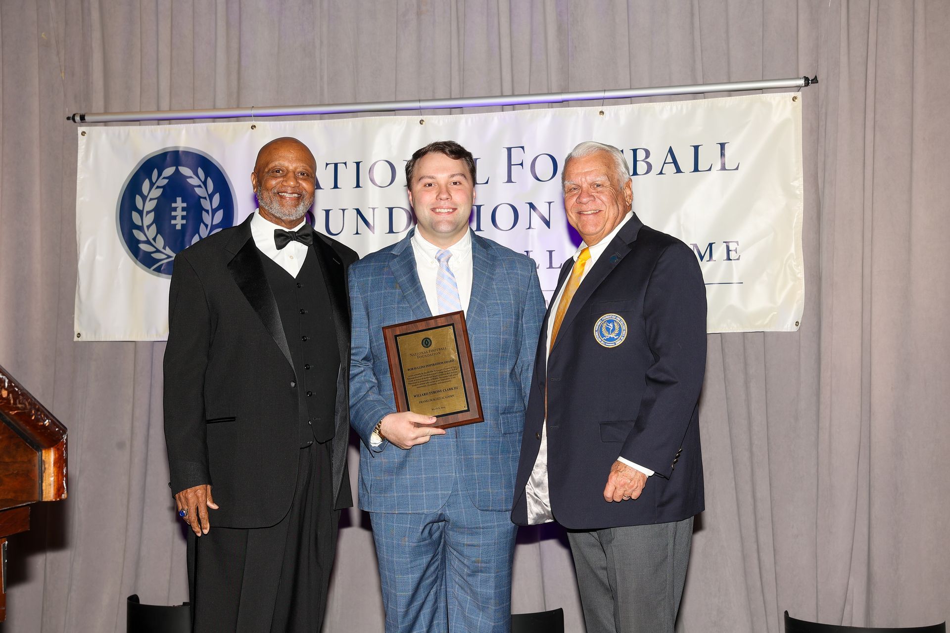 Accepting the award on behalf of Franklin Road Academy's Ty Clark is Joseph Holzmer.  