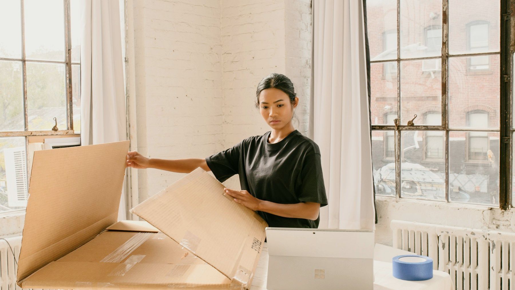 Small eCommerce business owner preparing a parcel for customer delivery