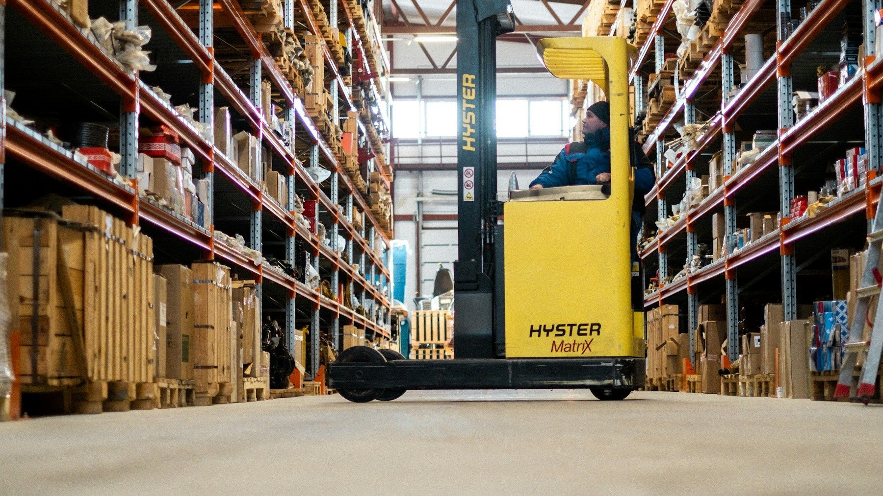Warehouse forklift and organised palletised goods prepared for commercial transport