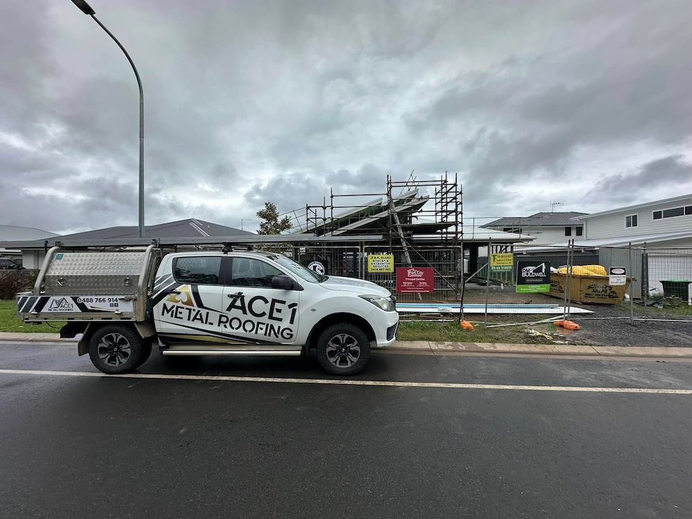 White Work Truck Parked in Front of a House Under Construction — Ace1 Metal Roofing in Taree, NSW