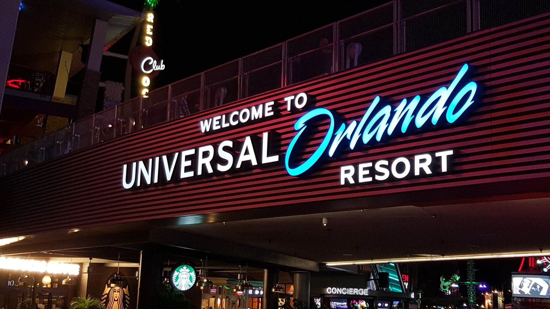 Welcome to Universal Orlando Resort sign at night.