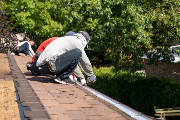 A group of men are working on a roof.