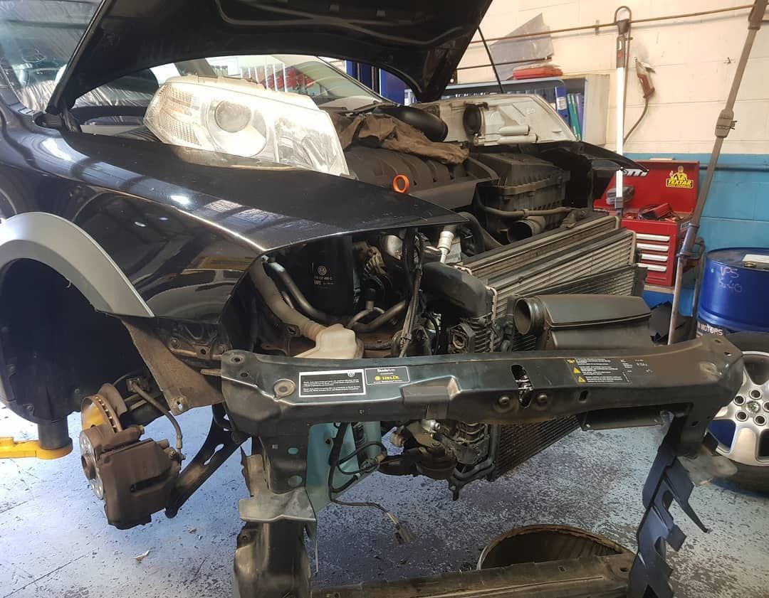 A Car with The Hood up Is Being Worked on In a Garage — Latin Motors in Fyshwick, ACT