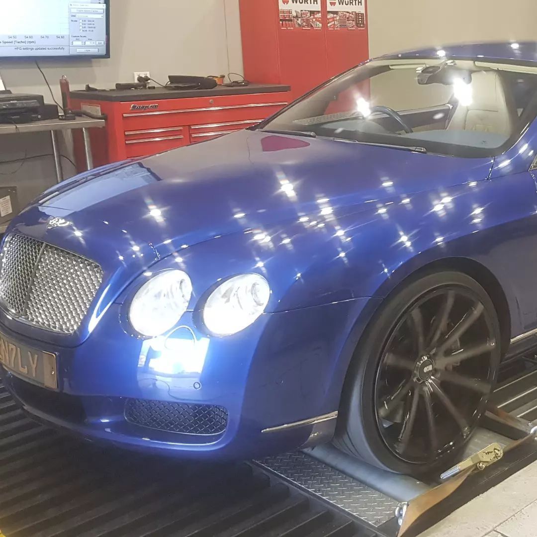 A Blue Bentley Is Sitting on A Ramp in A Garage — Latin Motors in Fyshwick, ACT
