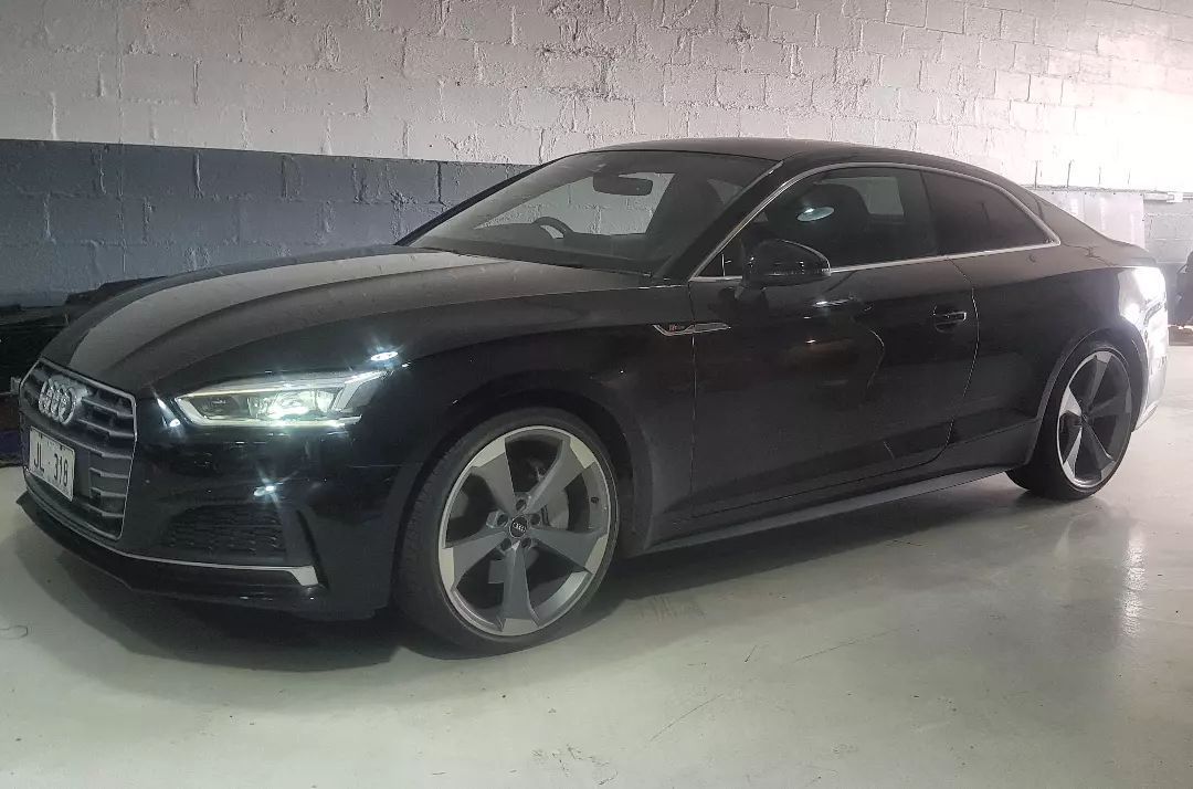 A Black Audi A5 Coupe Is Parked in A Garage — Latin Motors in Queanbeyan, ACT
