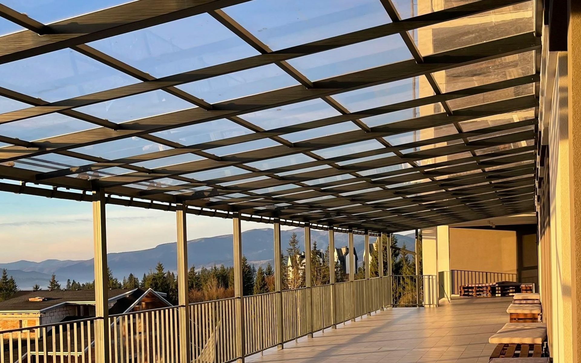 Alumawood patio cover with mountain views and glass railing.