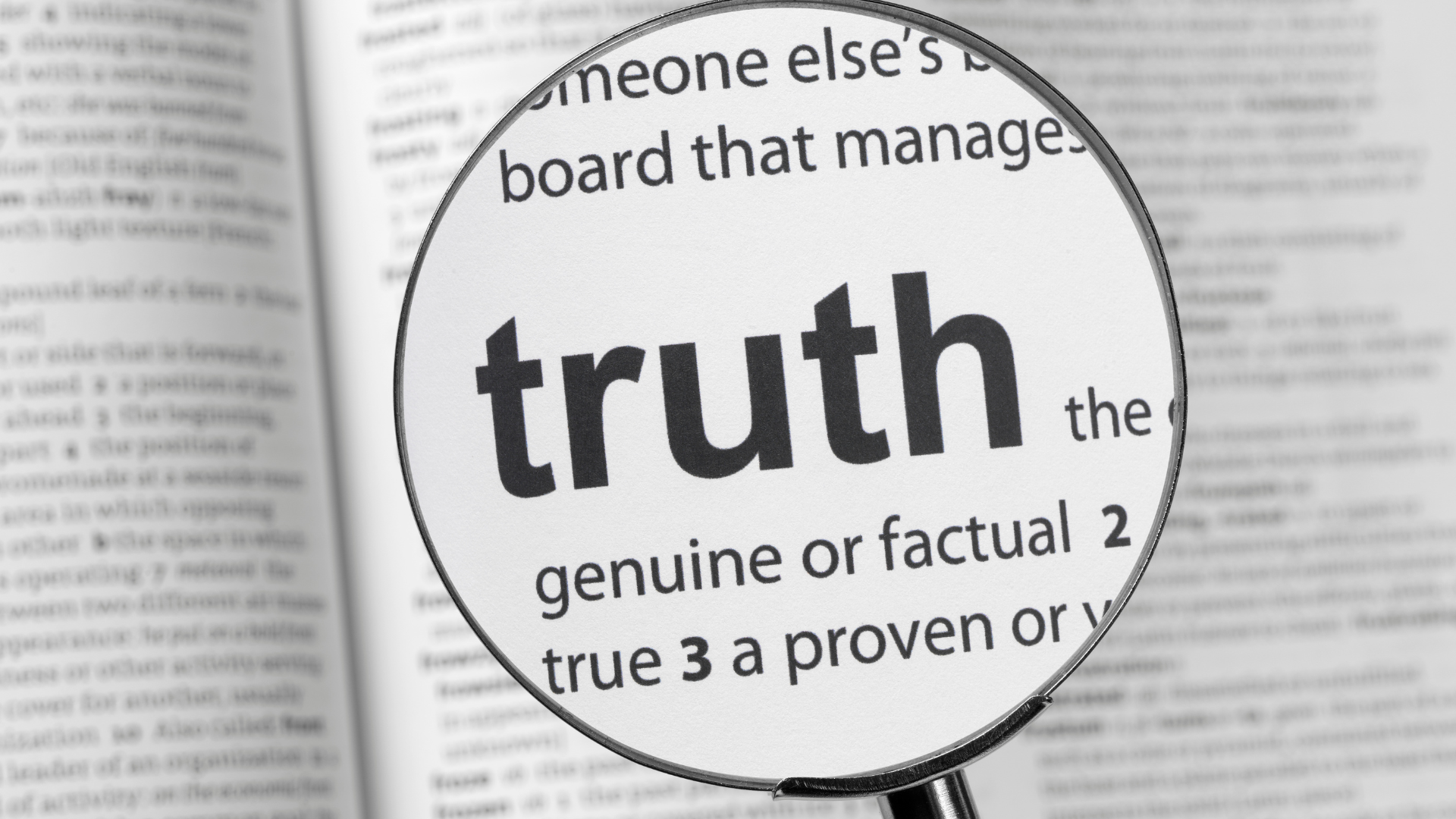 A magnifying glass with the word truth on it