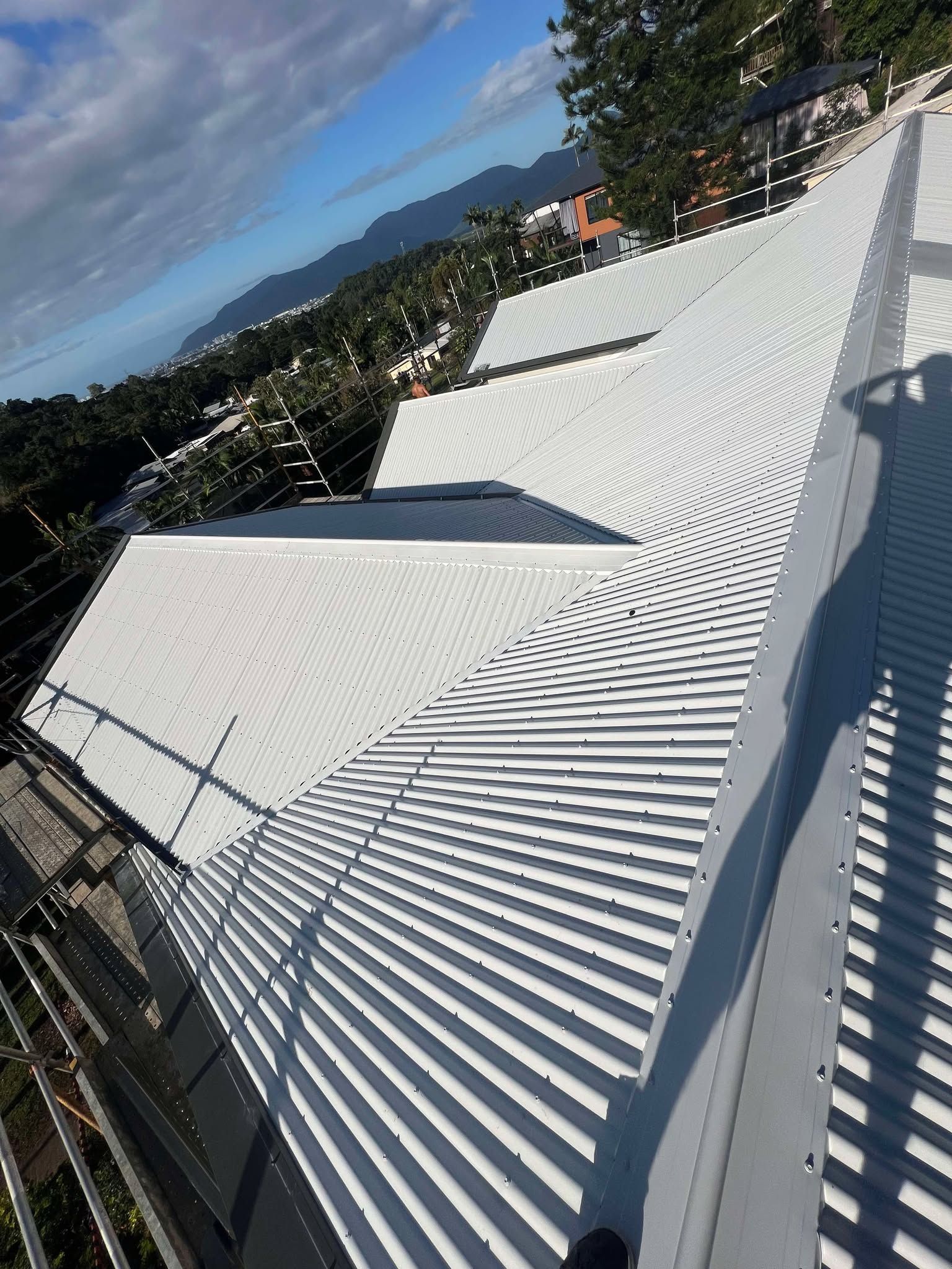 A white roof with a shadow of a person on it.