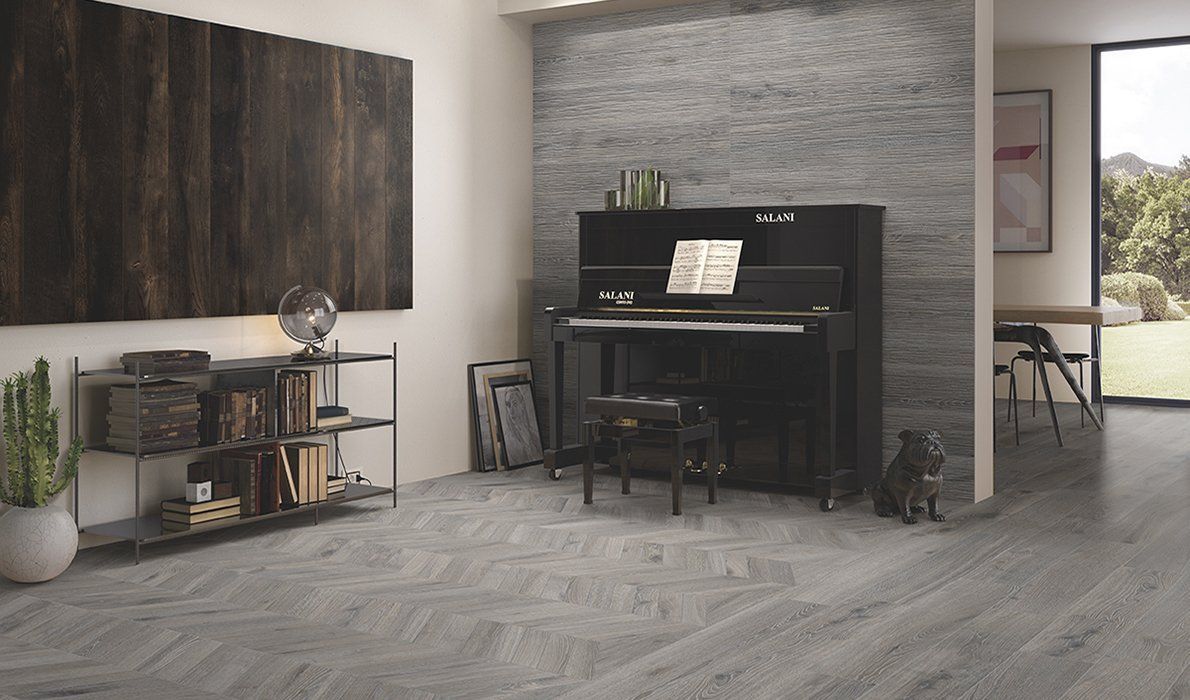 Soggiorno moderno con pianoforte verticale nero, parete grigia con texture e arredamento minimalista.