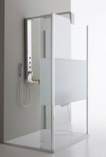 Box doccia moderno con pareti in vetro e comandi a parete in un bagno minimalista.