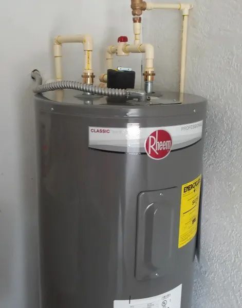 A rheem water heater is mounted to a wall