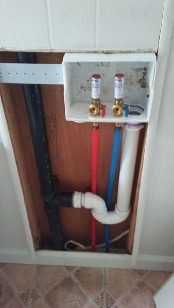 A picture of a plumbing system in a bathroom.