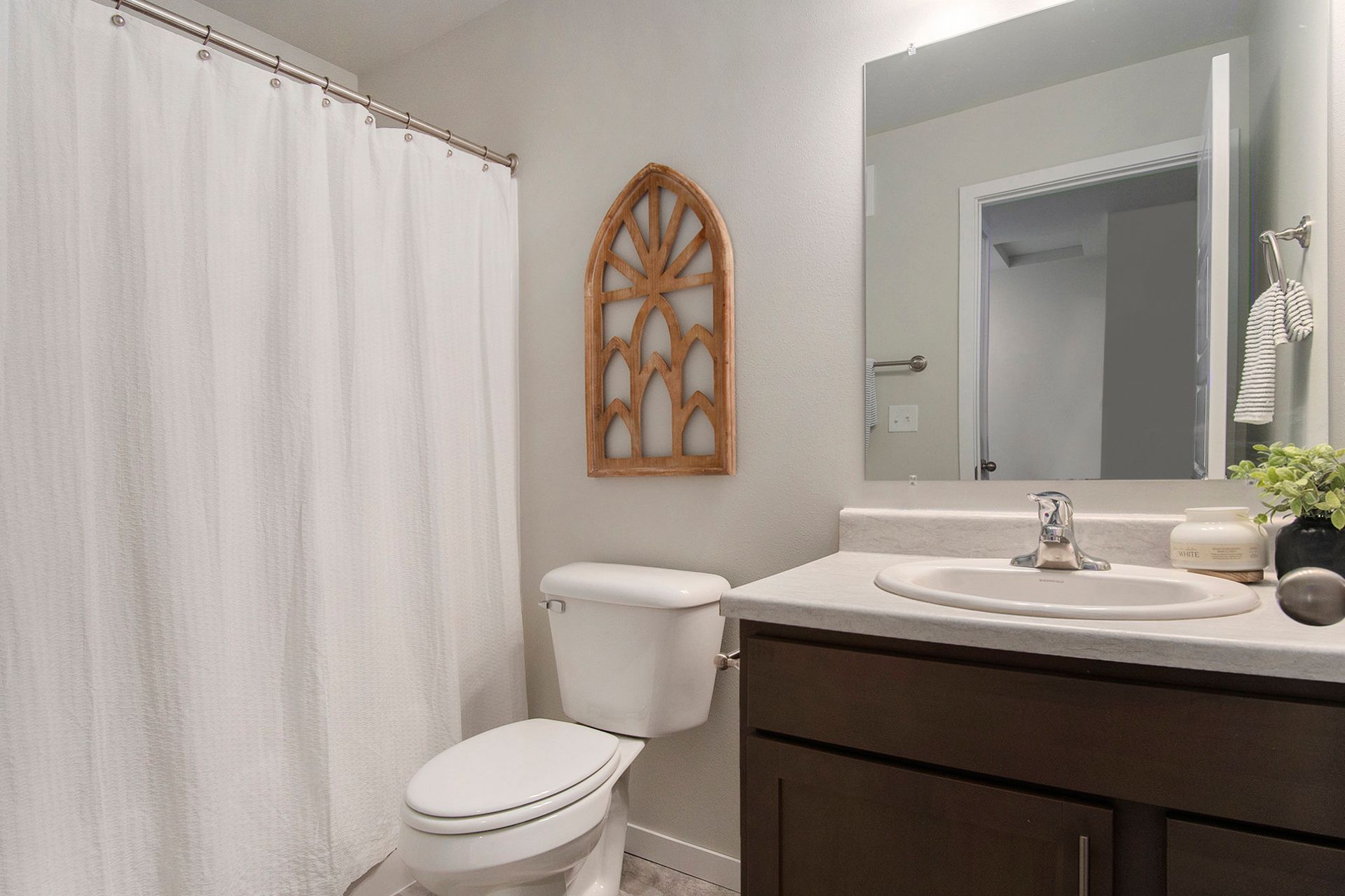 Bathroom with shower, toilet, and sink.