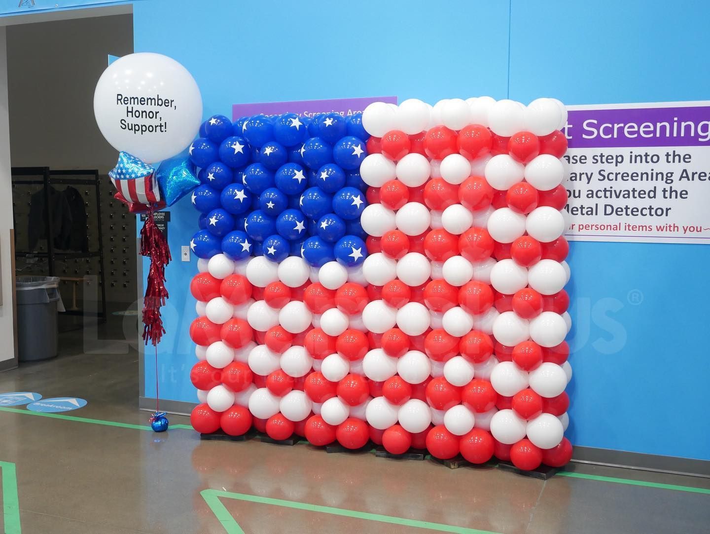 An american flag made of red white and blue balloons