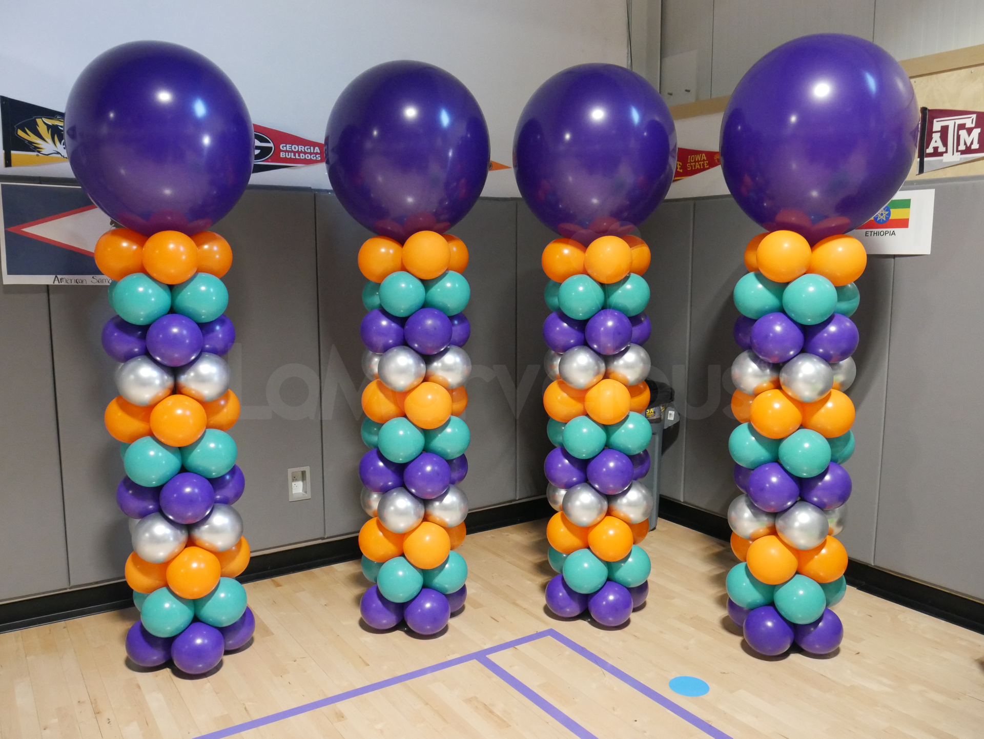 A bunch of balloons are stacked on top of each other in a room