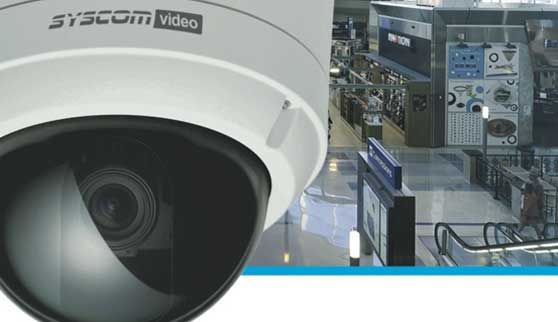 Una cámara de vídeo syscom está situada frente a una fábrica.