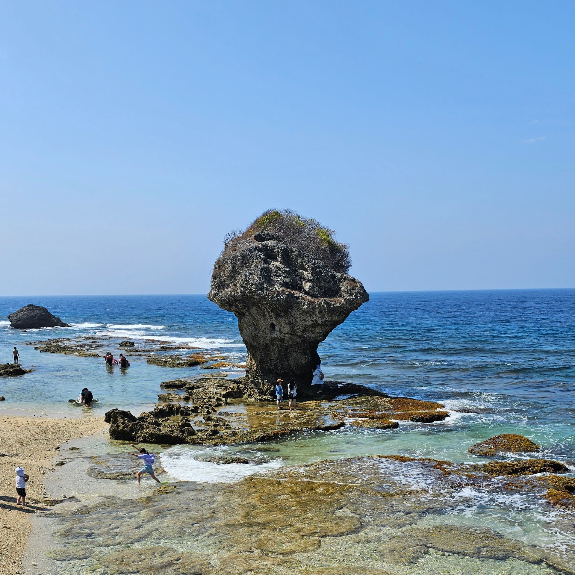 A large rock in the middle of the ocean