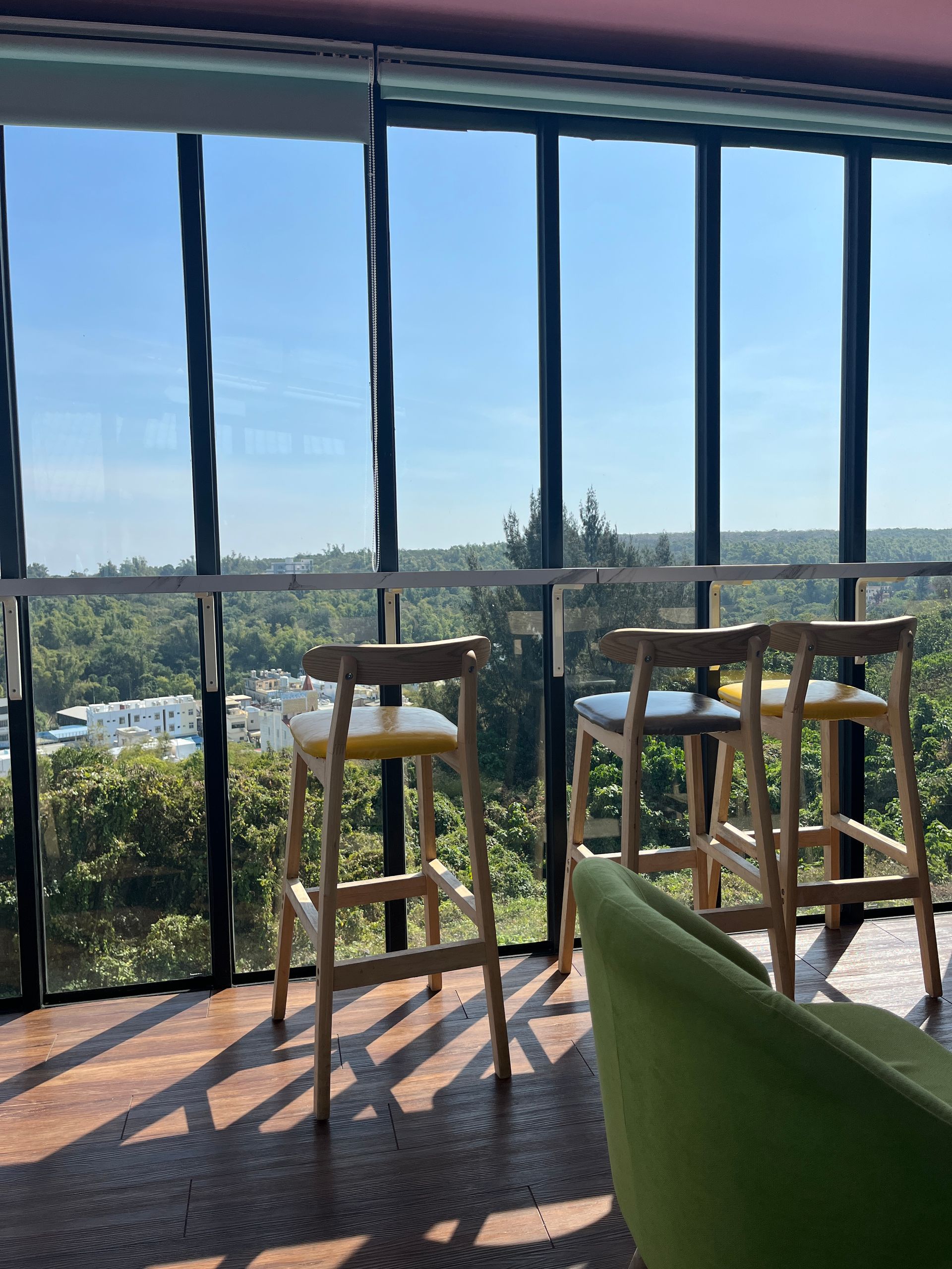 A room with a lot of windows and stools
