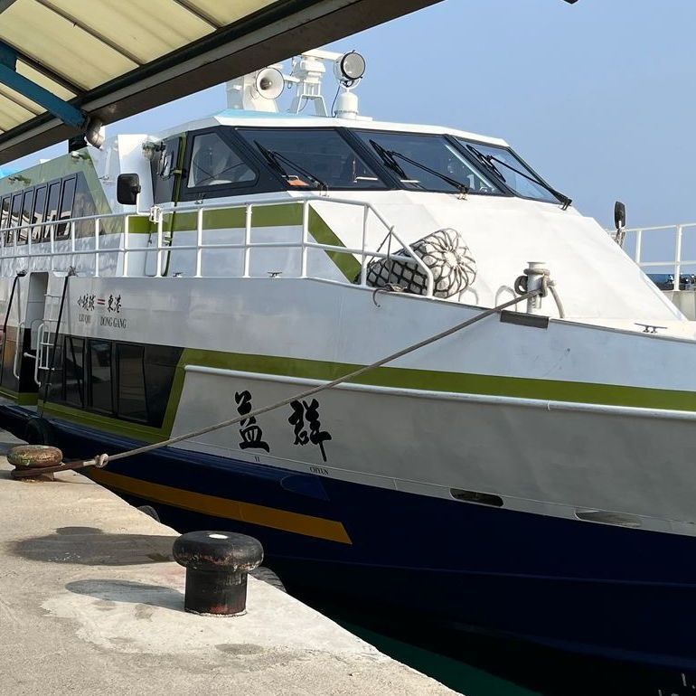 A large white boat with chinese writing on the side