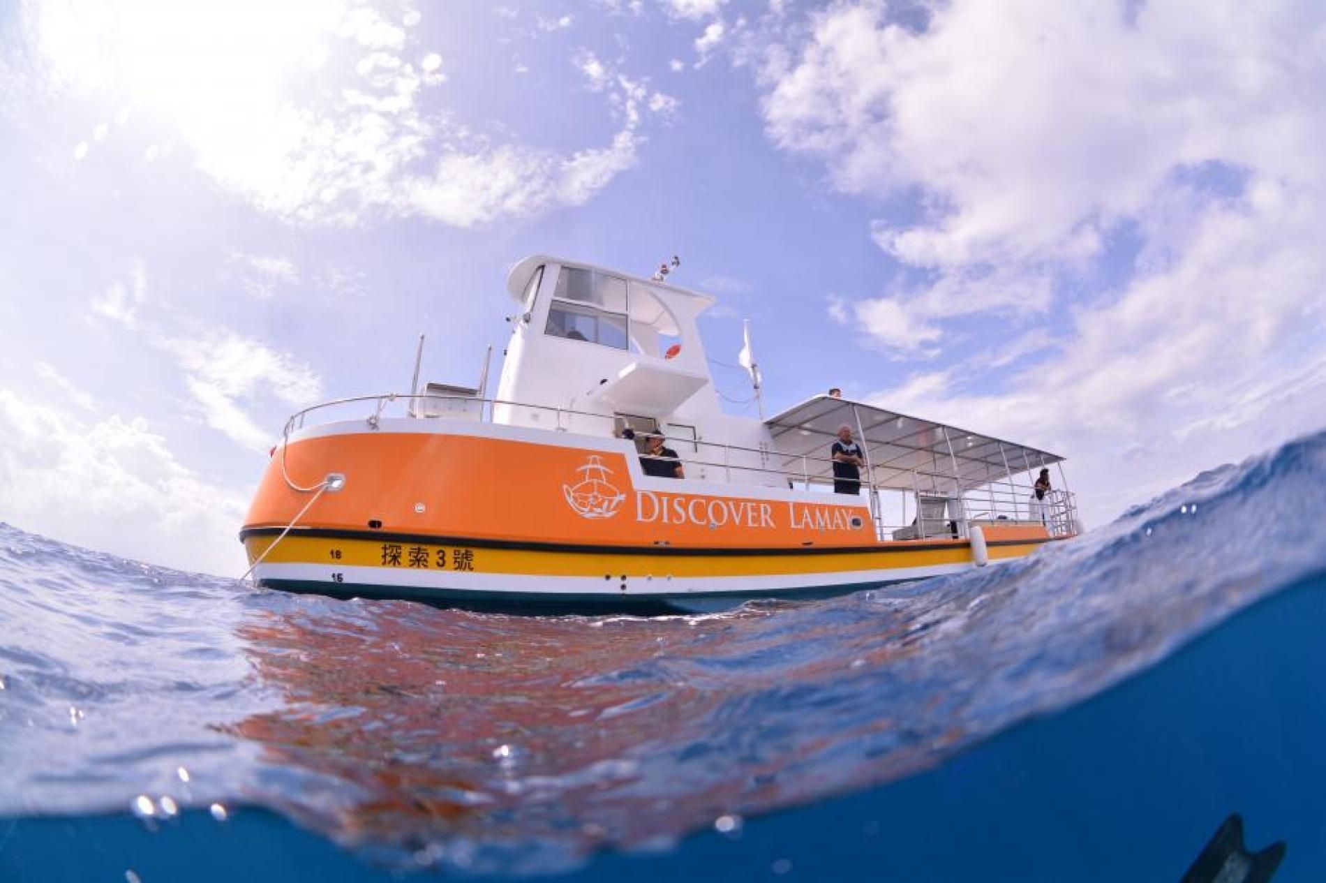 A boat is floating on top of a body of water.